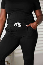 Load image into Gallery viewer, Double Take Asymmetrical Neck Tied Jumpsuit with Pockets